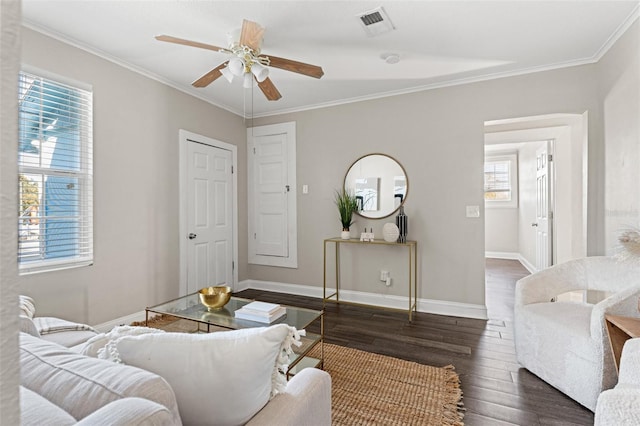 living area featuring ornamental molding, visible vents, baseboards, and wood finished floors