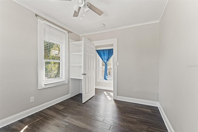 unfurnished bedroom with a ceiling fan, baseboards, dark wood-type flooring, and crown molding