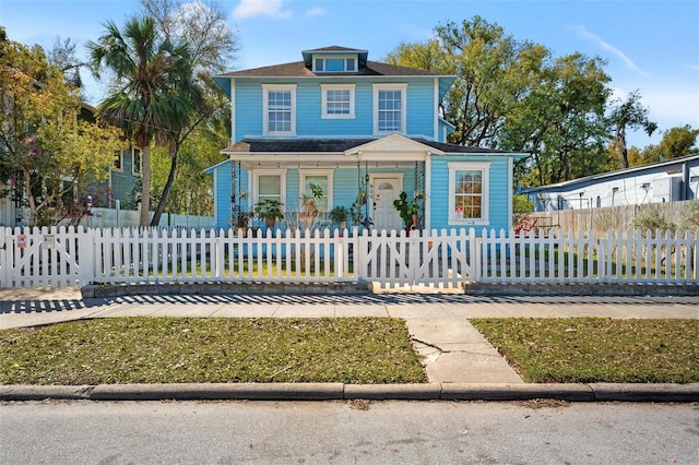 view of front of home featuring a fenced front yard and covered porch