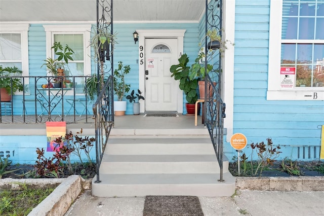 entrance to property featuring a porch