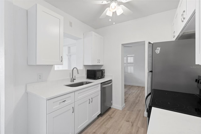 kitchen with white cabinetry, a ceiling fan, appliances with stainless steel finishes, and a sink