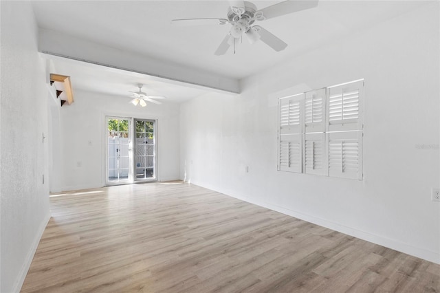 empty room featuring wood finished floors, a ceiling fan, baseboards, and beam ceiling