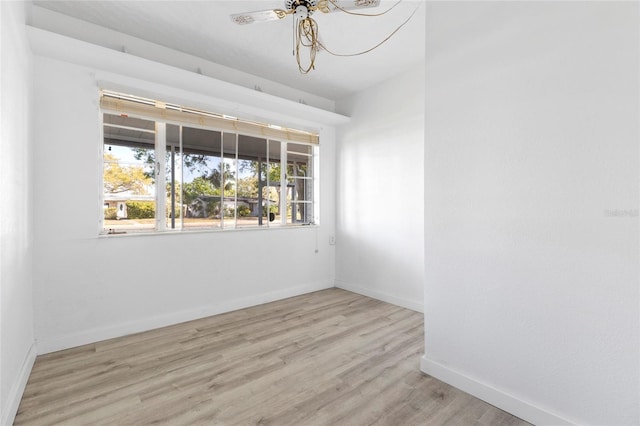 empty room with baseboards and wood finished floors