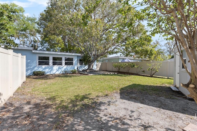 view of yard with a fenced backyard