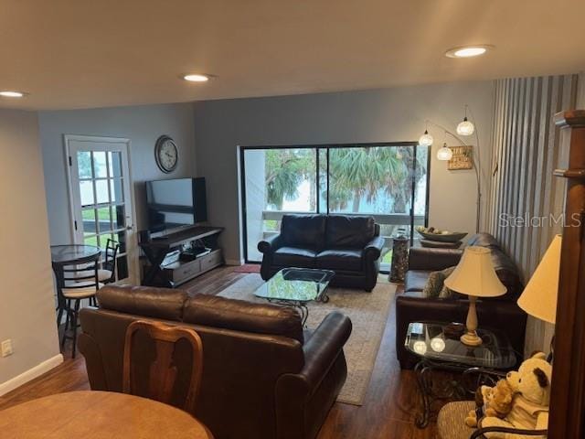 living room with recessed lighting, wood finished floors, and baseboards