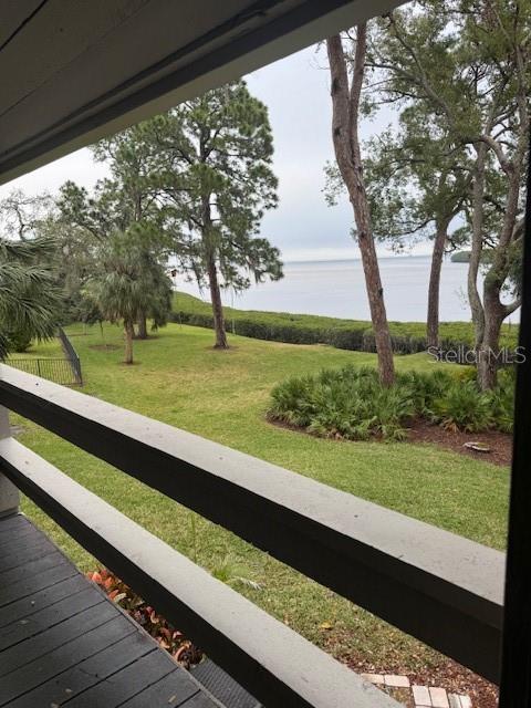 exterior space featuring a water view, a yard, and fence