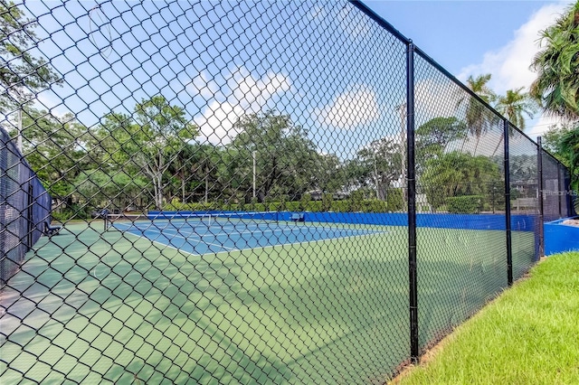 view of tennis court featuring fence