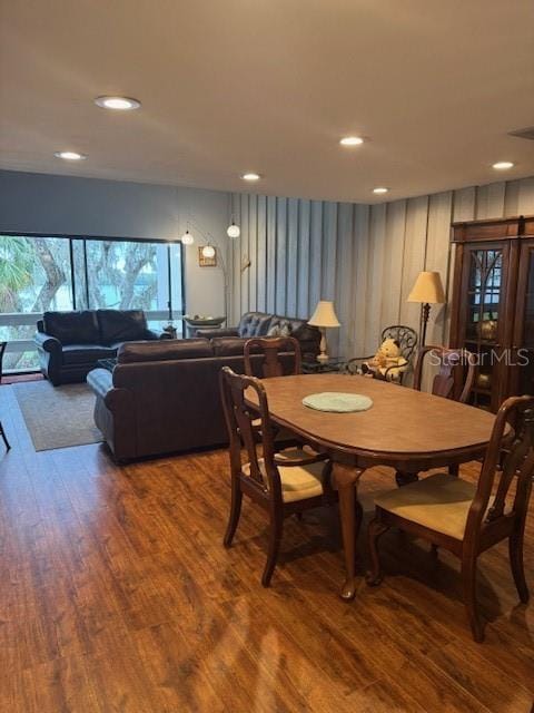 dining area featuring wood finished floors and recessed lighting