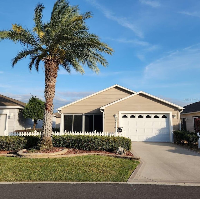 ranch-style home featuring a garage and driveway