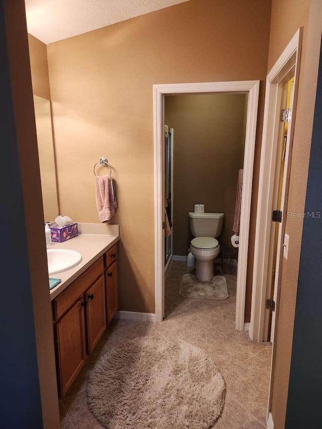 full bath featuring toilet, tile patterned flooring, and vanity