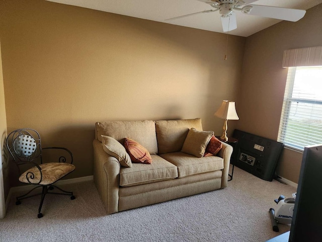 living room featuring a ceiling fan, lofted ceiling, light colored carpet, and baseboards