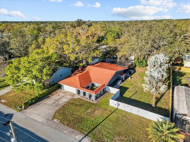 birds eye view of property featuring a view of trees