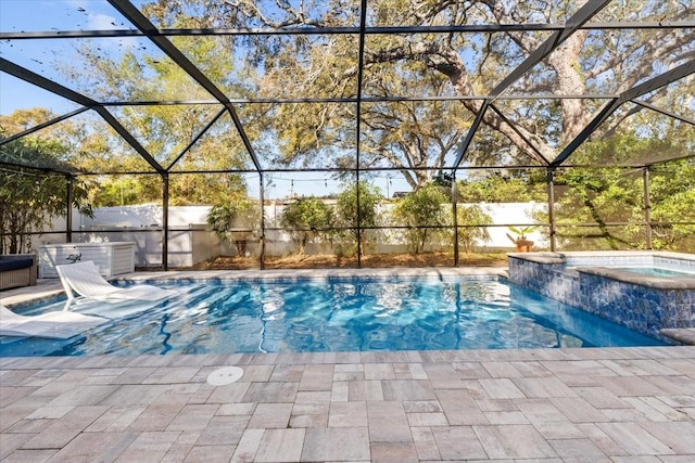 view of swimming pool with a patio area, a lanai, and a pool with connected hot tub