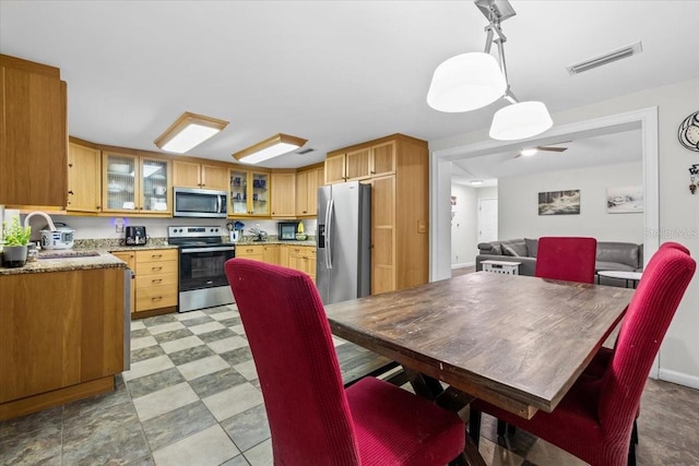 dining area with visible vents, baseboards, and light floors