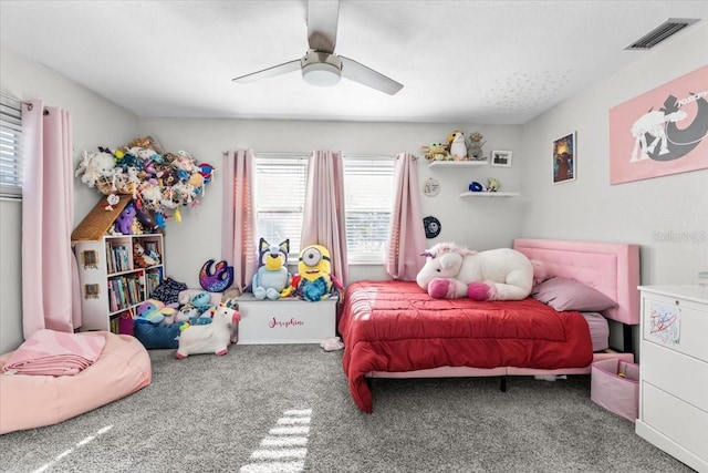 carpeted bedroom featuring visible vents and a ceiling fan