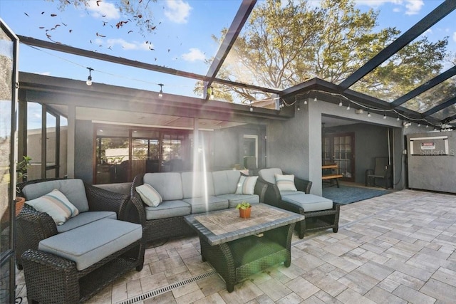 view of patio / terrace with an outdoor living space and glass enclosure