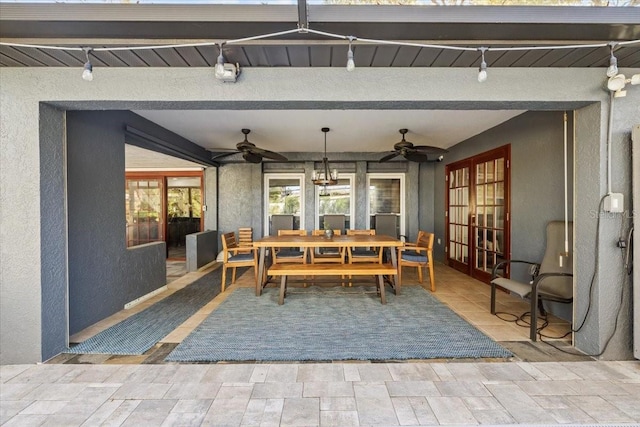 view of patio with french doors, outdoor dining area, and ceiling fan