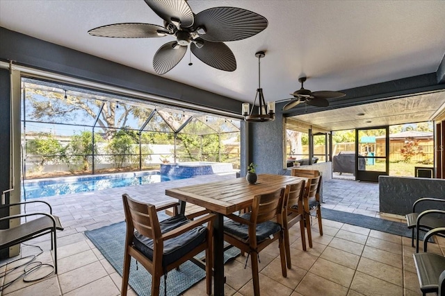 view of patio featuring outdoor dining space, fence, glass enclosure, an outdoor pool, and ceiling fan