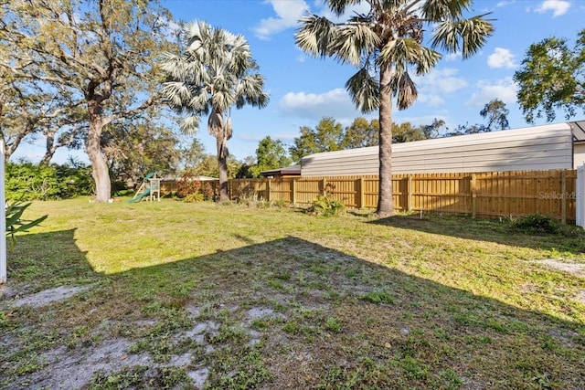 view of yard featuring a playground and fence