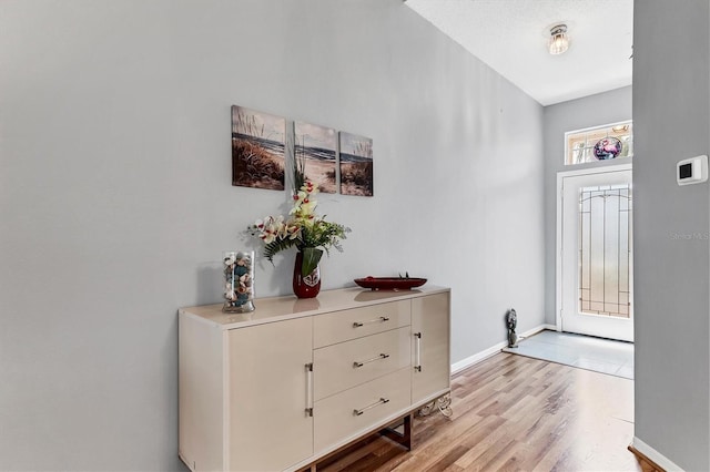 interior space featuring light wood-style flooring and baseboards