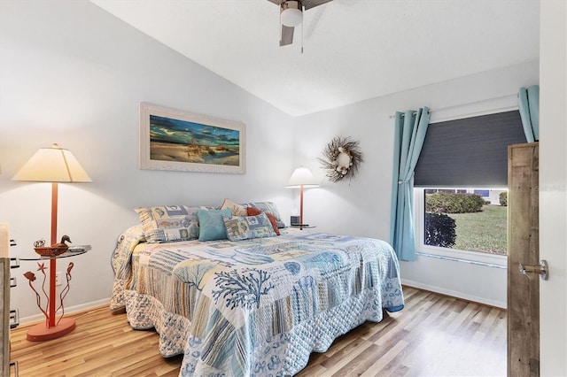 bedroom with vaulted ceiling, ceiling fan, wood finished floors, and baseboards