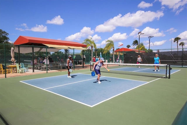 view of tennis court with fence