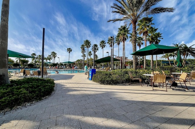 surrounding community featuring a pool and a patio area