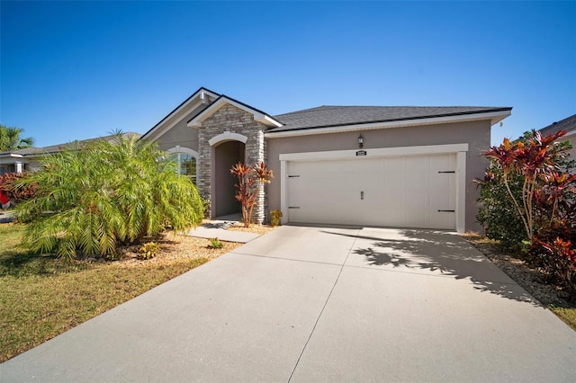 view of front facade featuring stone siding, driveway, an attached garage, and stucco siding