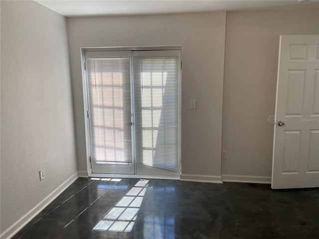 empty room featuring baseboards