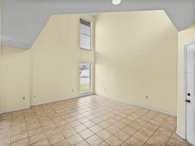 interior space with high vaulted ceiling and baseboards