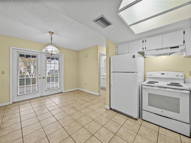 kitchen with a textured ceiling, under cabinet range hood, white appliances, visible vents, and white cabinets