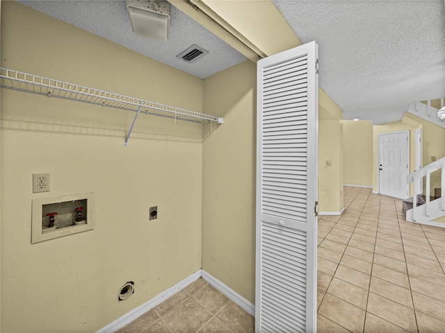 clothes washing area featuring laundry area, light tile patterned floors, visible vents, hookup for a washing machine, and hookup for an electric dryer