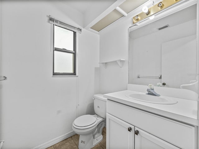 half bathroom featuring vanity, toilet, and tile patterned floors