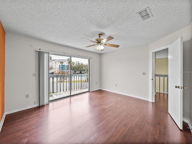 spare room featuring ceiling fan, a textured ceiling, visible vents, and wood finished floors