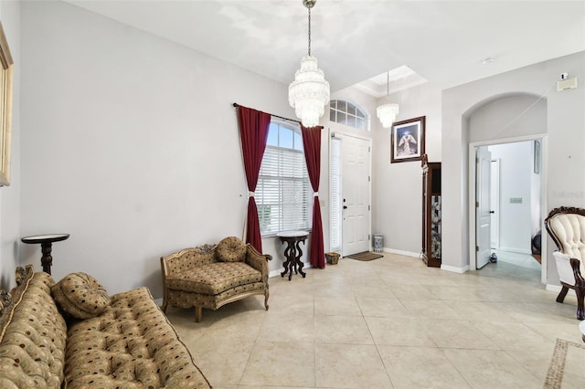 sitting room featuring light tile patterned floors, baseboards, and an inviting chandelier