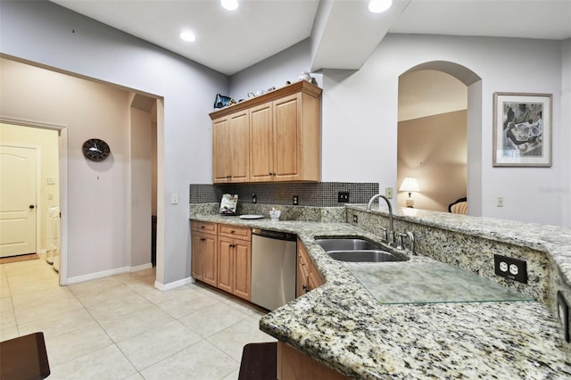 kitchen featuring light tile patterned flooring, light stone countertops, a sink, decorative backsplash, and dishwasher