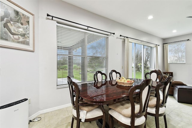 dining room featuring light tile patterned floors, baseboards, and recessed lighting