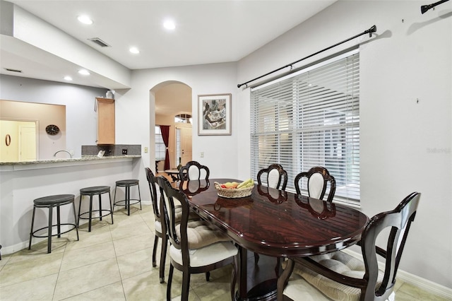 dining room with arched walkways, light tile patterned flooring, recessed lighting, visible vents, and baseboards