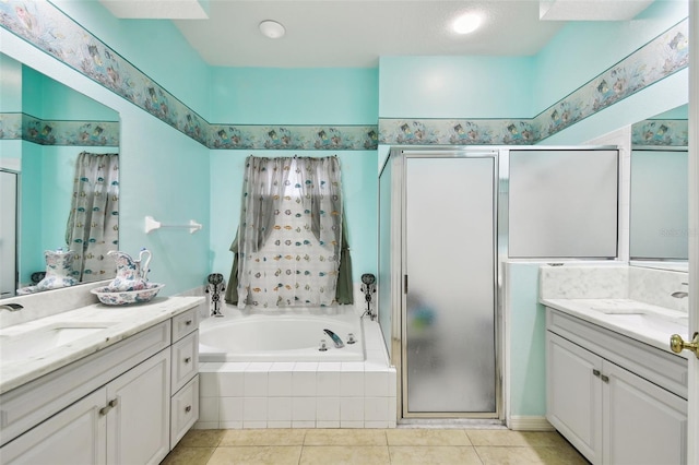 bathroom with a stall shower, two vanities, and a sink