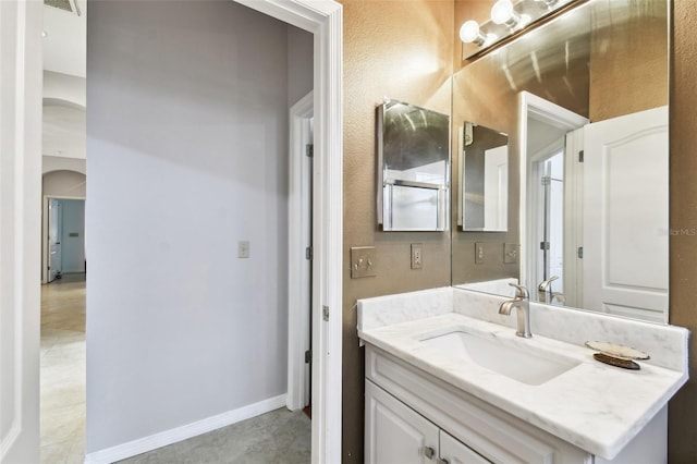 bathroom with visible vents, vanity, and baseboards