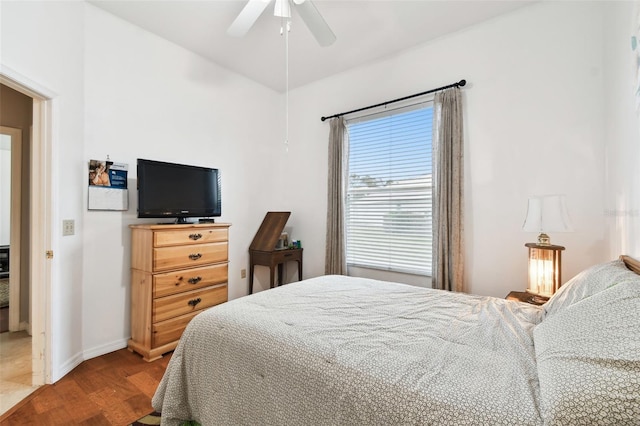 bedroom with ceiling fan, wood finished floors, lofted ceiling, and baseboards