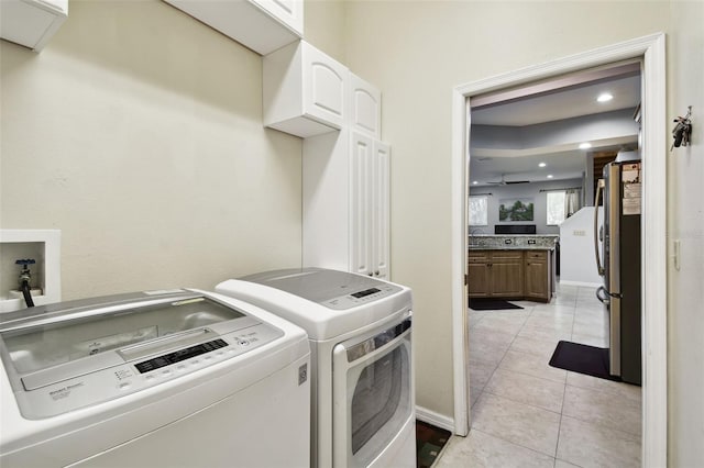 washroom with washer and clothes dryer, recessed lighting, cabinet space, light tile patterned flooring, and baseboards