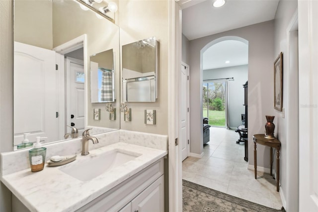 bathroom featuring tile patterned flooring, vanity, baseboards, and recessed lighting