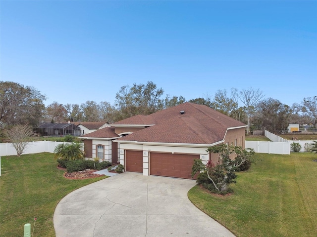 mediterranean / spanish-style home with a garage, concrete driveway, fence, and a front lawn