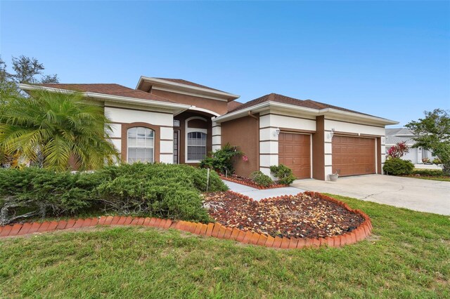 3613 Pendleton Way, Land O Lakes, FL 34639 - view of front of property featuring stucco siding, driveway, an attached garage, and a front yard