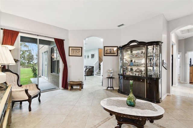 3613 Pendleton Way, Land O Lakes, FL 34639 - living room with arched walkways, light tile patterned floors, and stairway