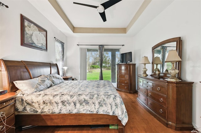 3613 Pendleton Way, Land O Lakes, FL 34639 - bedroom featuring access to outside, wood finished floors, a raised ceiling, and ceiling fan