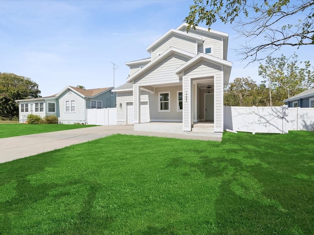 view of front of house with fence, driveway, and a front lawn