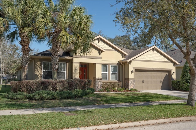 view of front facade featuring driveway, stone siding, stucco siding, an attached garage, and a front yard