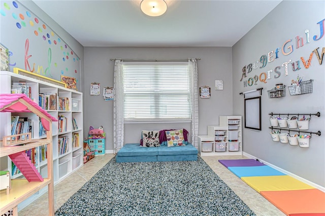 playroom with tile patterned flooring and baseboards